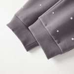 Gray sweatpant with star patterns on a white background