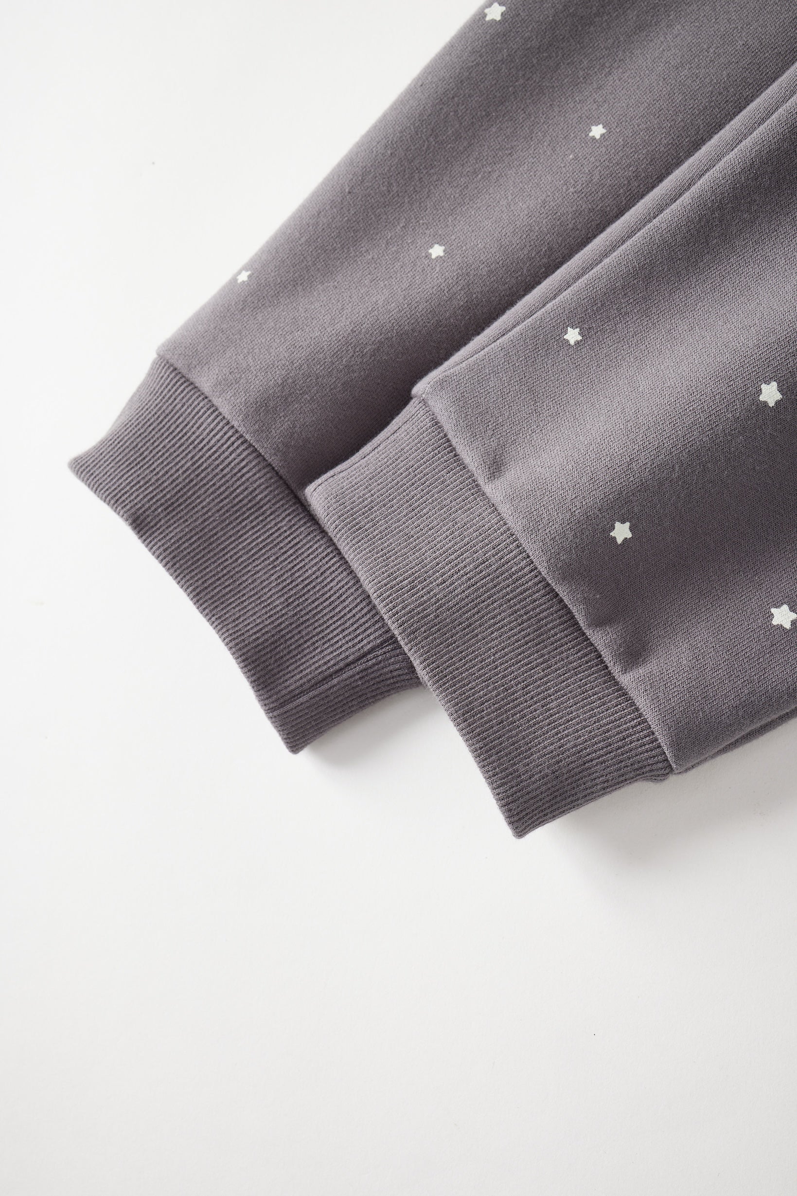 Gray sweatpant with star patterns on a white background