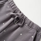 Gray sweatpants with star patterns on a light gray background