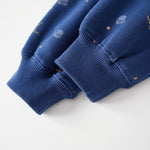 Close-up of a blue sweater with small patterns on a white background