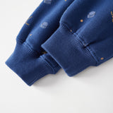 Close-up of a blue sweater with small patterns on a white background