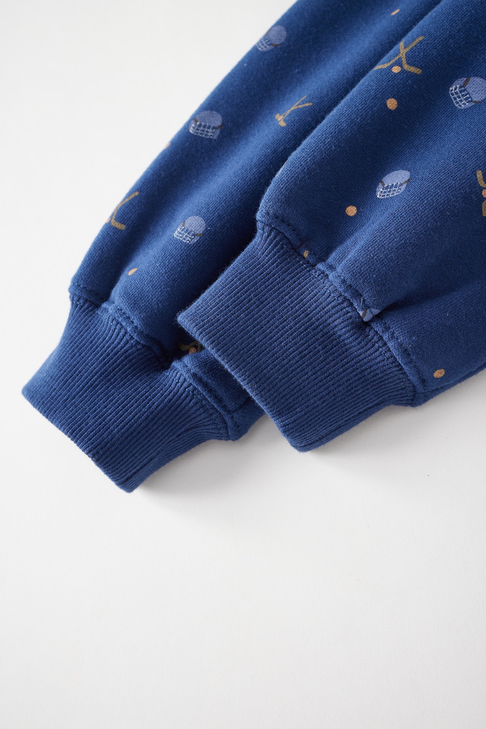 Close-up of a blue sweater with small patterns on a white background