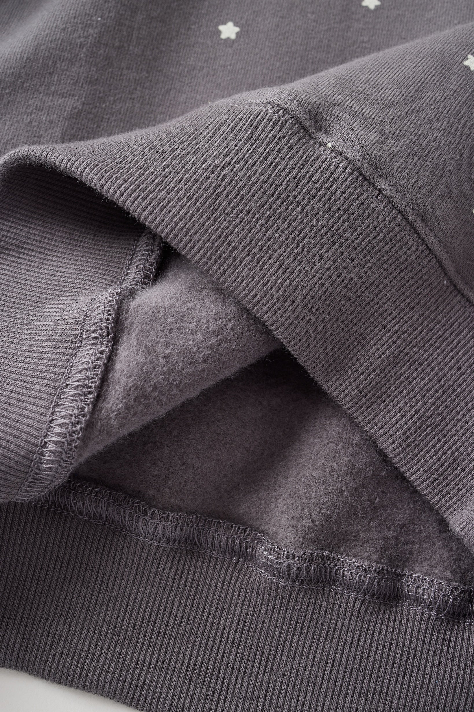 Close-up of a dark gray fabric with textured edge