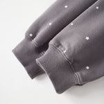 Gray sweatshirt with star patterns on a light gray background