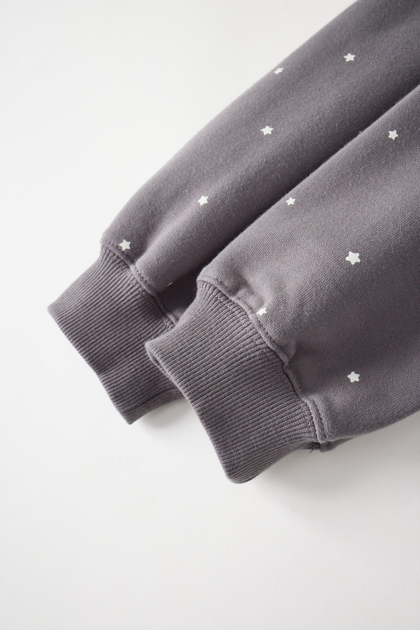 Gray sweatshirt with star patterns on a light gray background