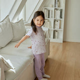 baby girl is standing beside the sofa