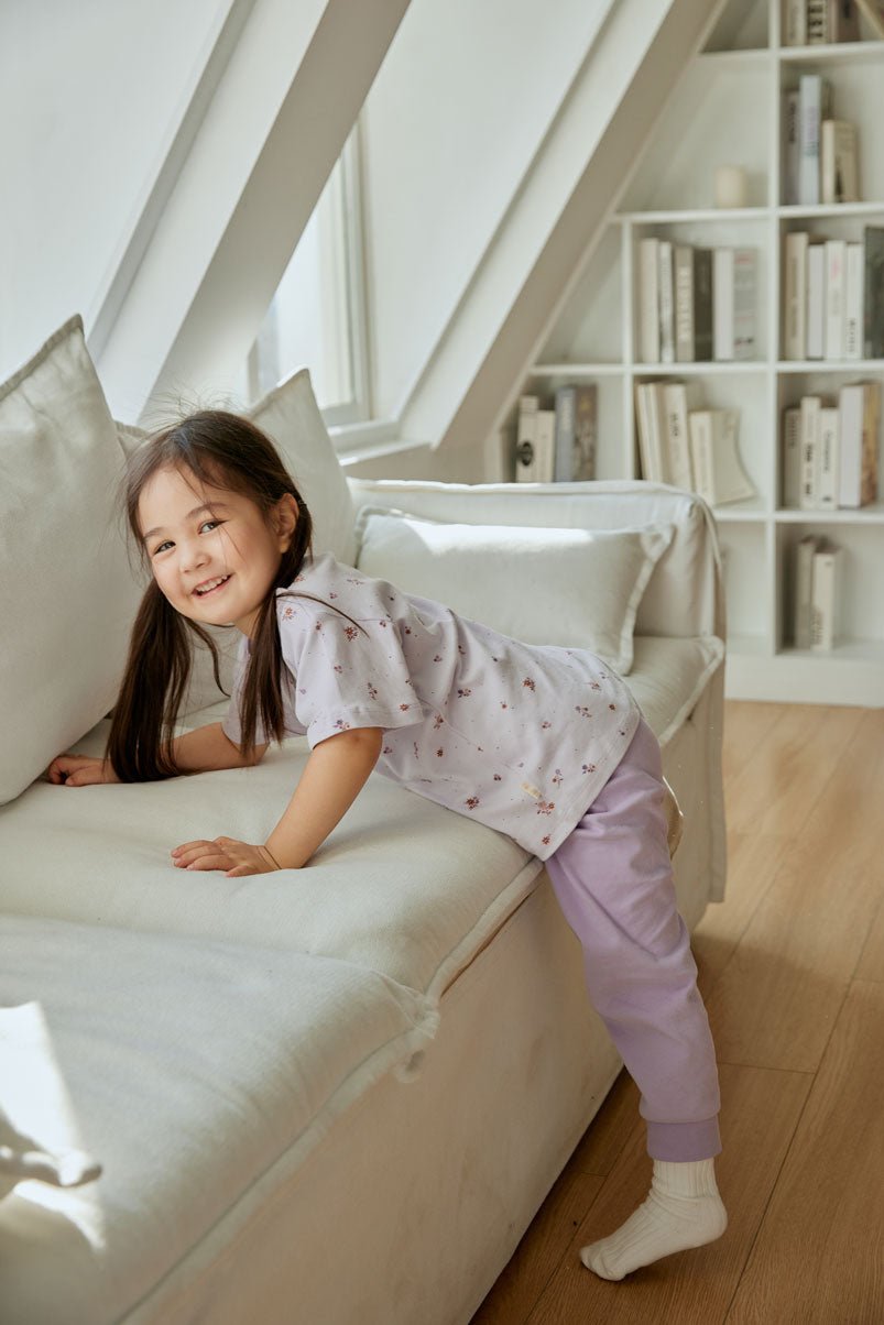 baby girl climbing the sofa