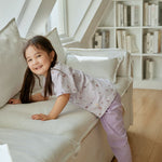 baby girl climbing the sofa
