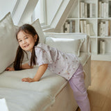 baby girl climbing the sofa