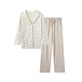 women pajama top and beige pants on a white background