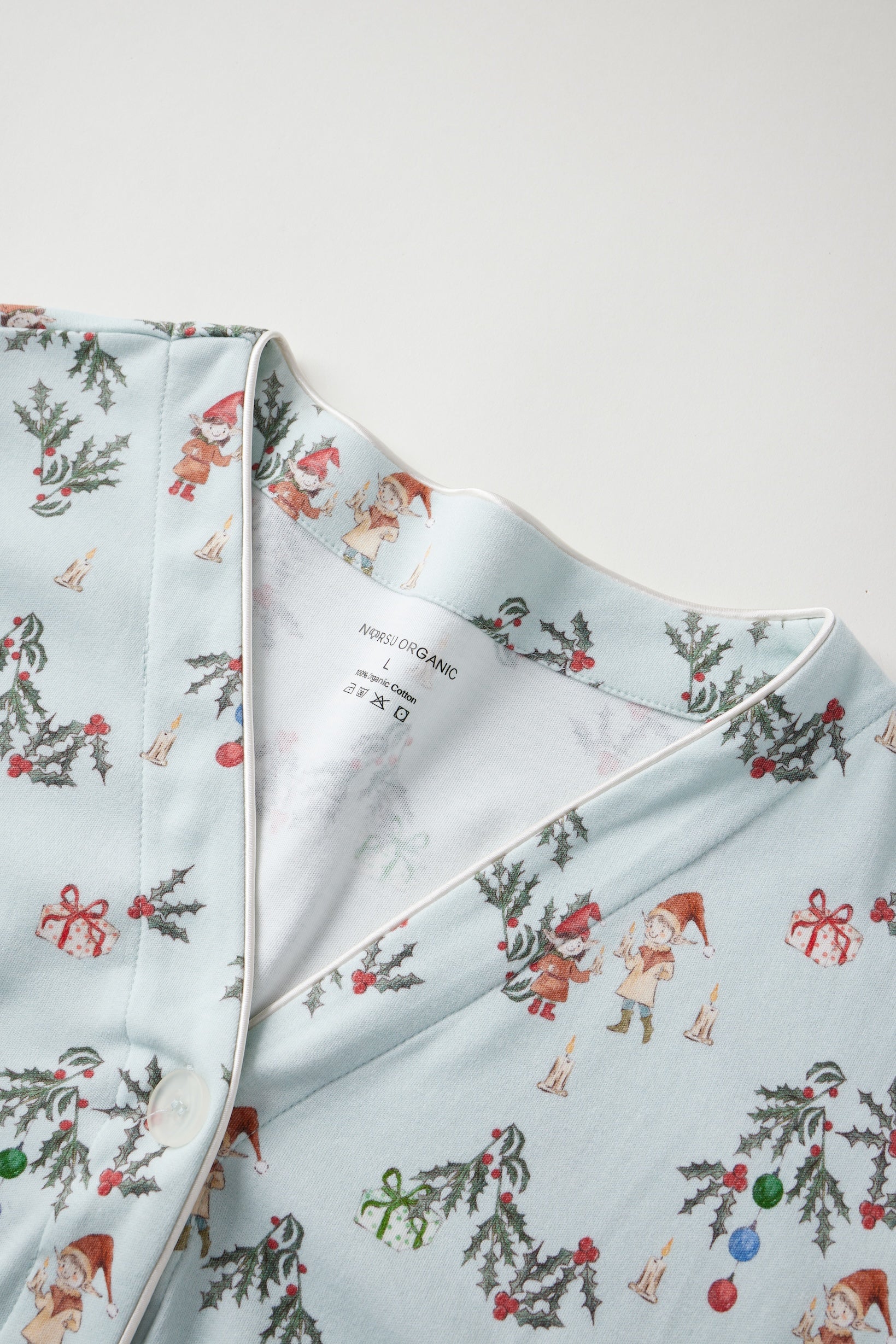 Light blue fabric with Christmas-themed pattern on a white background