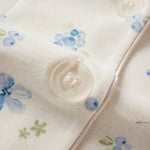 Close-up of a fabric with floral patterns and buttons.