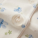 Close-up of a fabric with floral patterns and buttons.