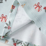 Christmas-themed fabric with reindeer, holly, and presents on a white background