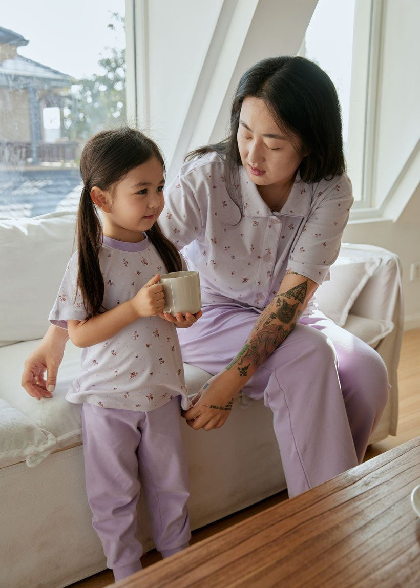 mom tidying up her daughter's pajama